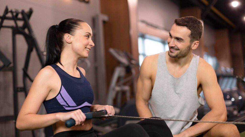 Man and woman in the gym discussing nutritional coaching. Example of referral marketing.